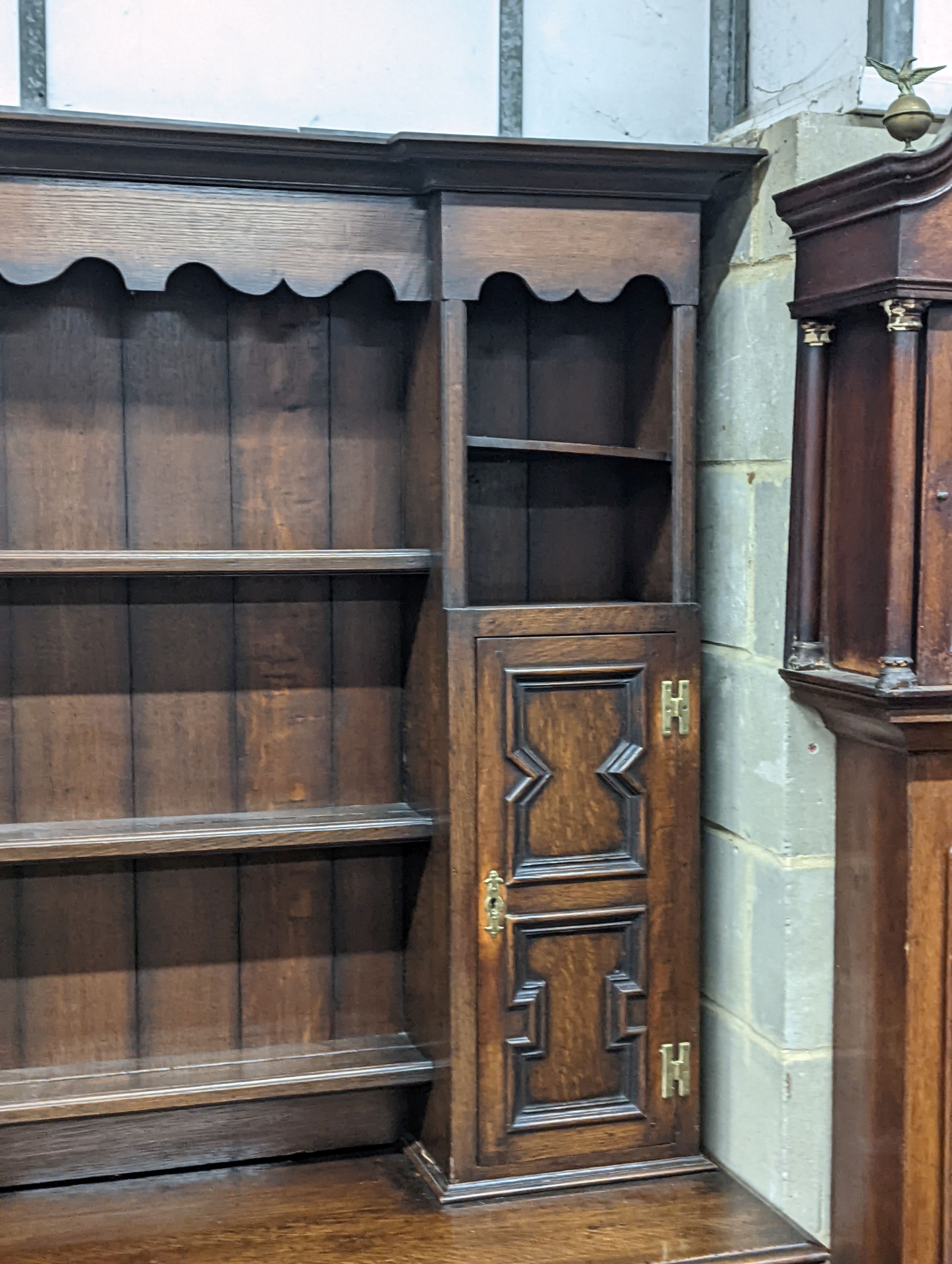 An early 20th century Jacobean revival oak dresser, width 168cm, depth 48cm, height 218cm